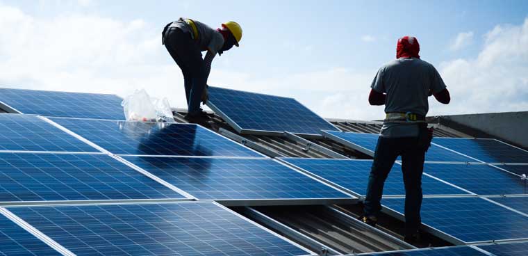 solar panels being installed on a house (surasak jailak/Shutterstock.com)