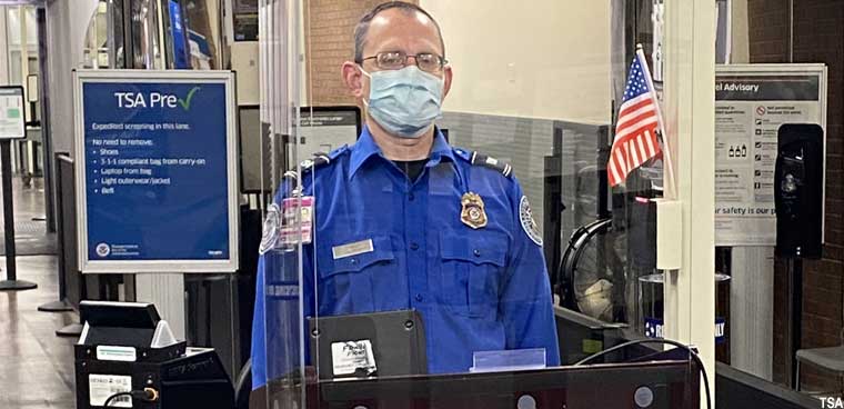 TSA airport screener with mask (TSA)